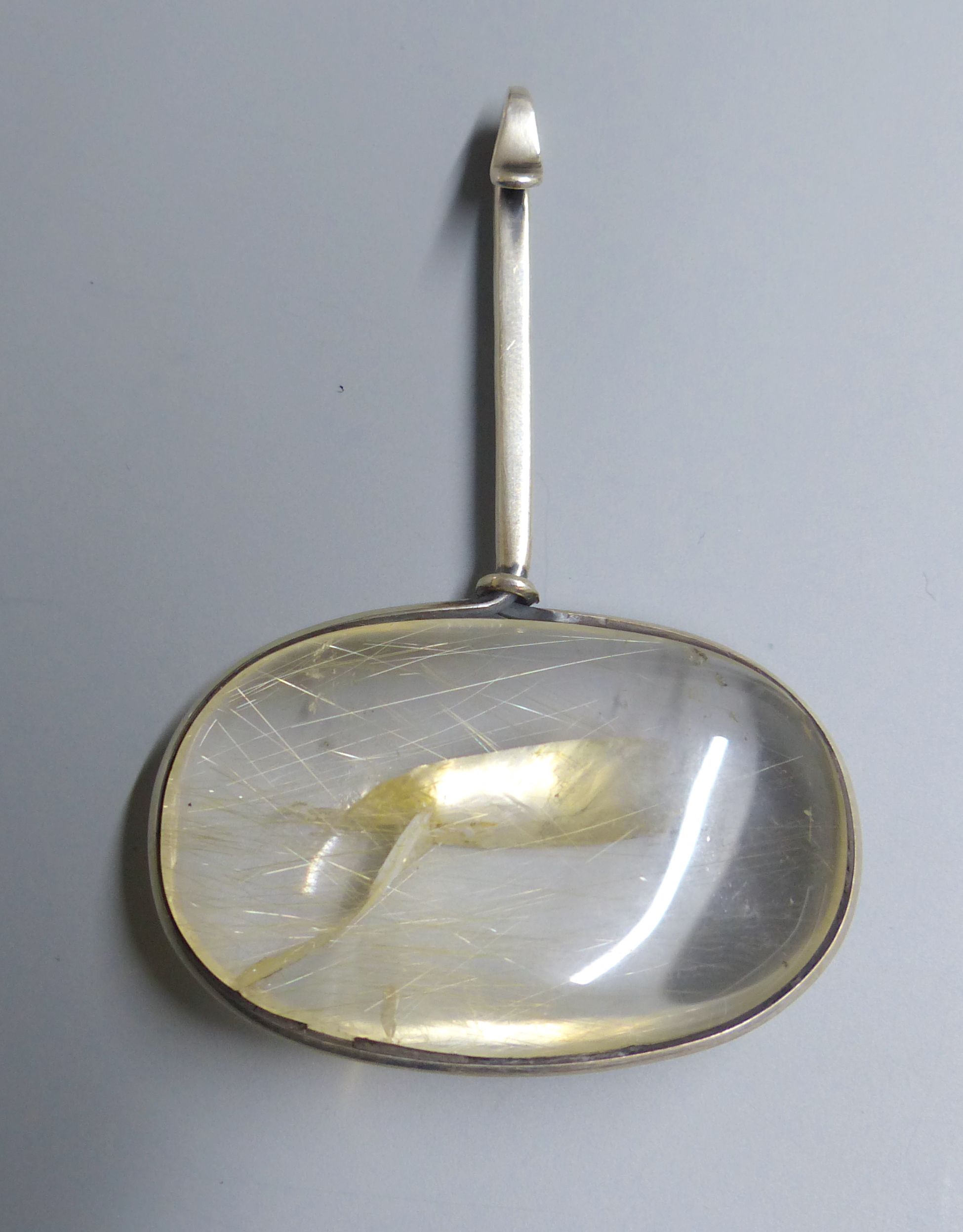 A Georg Jensen sterling and rutilated quartz set Vivianna Torun oval pendant, no. 133, 65mm.